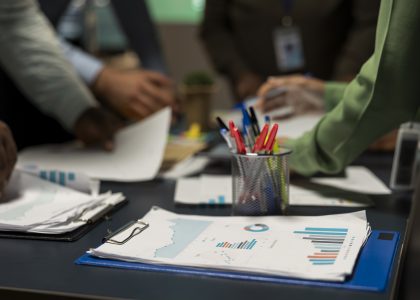 HabtAudit – Independent Audit & Advisory Firm in Ethiopia | close up diverse business team exchanging insights forecasting diagrams late night